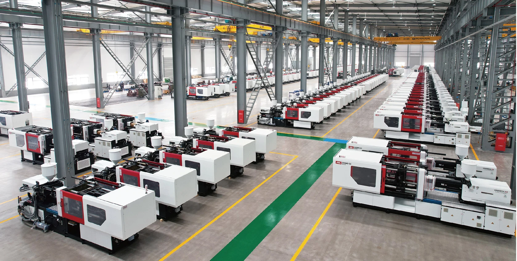 Rows of HWAMDA injection molding machines in assembly